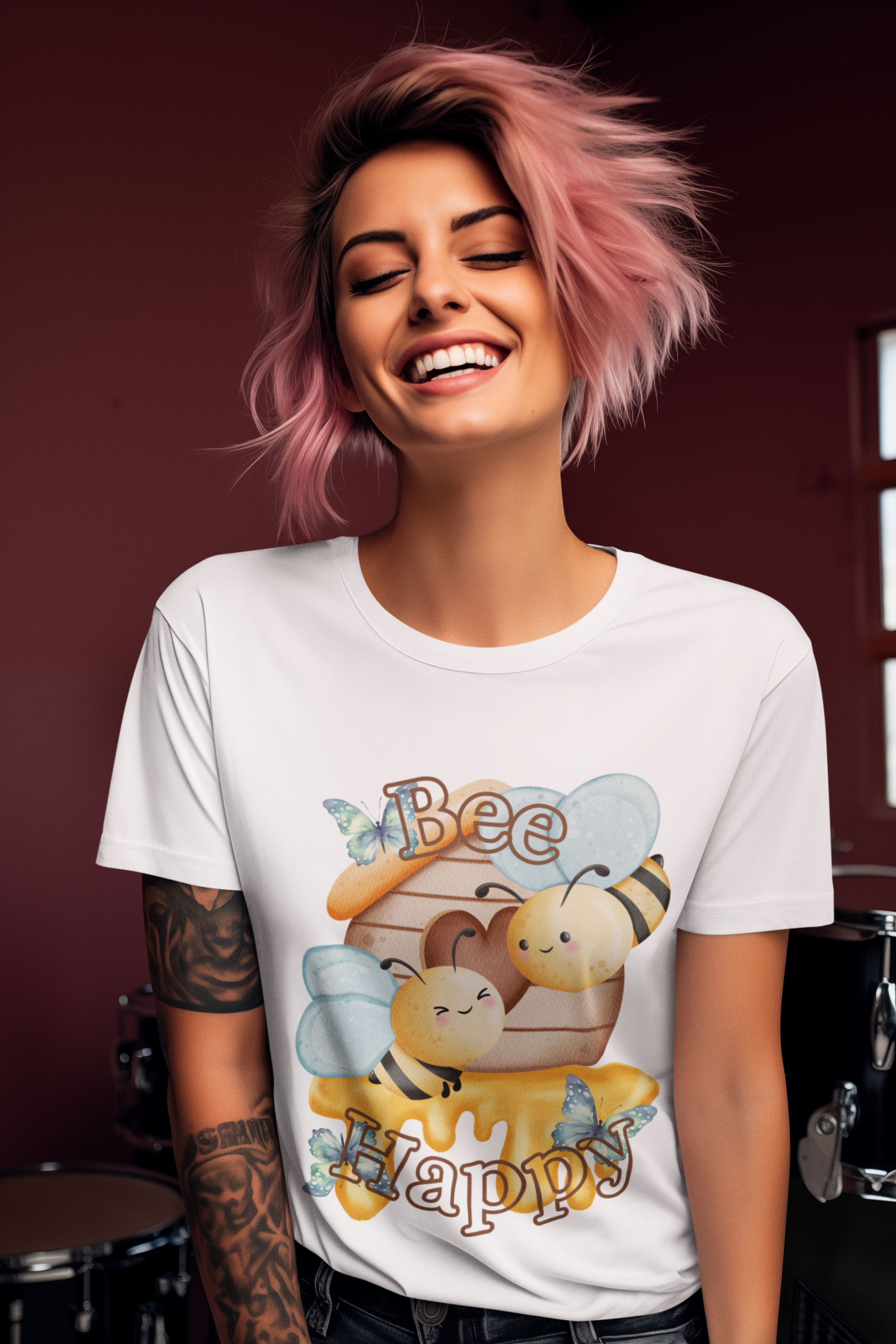 Woman wearing a white t-shirt with a bee-themed design, smiling against a dark background.
