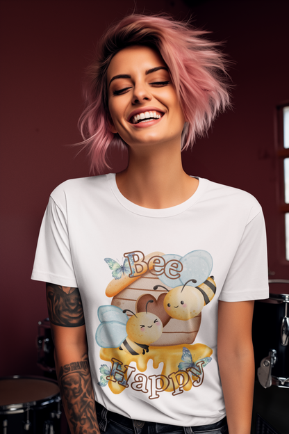 Woman wearing a white t-shirt with a bee-themed design, smiling against a dark background.